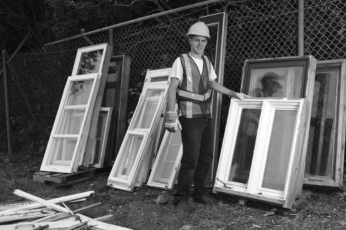 Builder placing a skip on a construction site in Chiswick